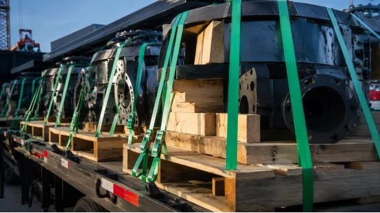 Heavy machinery strapped on flatbed truck